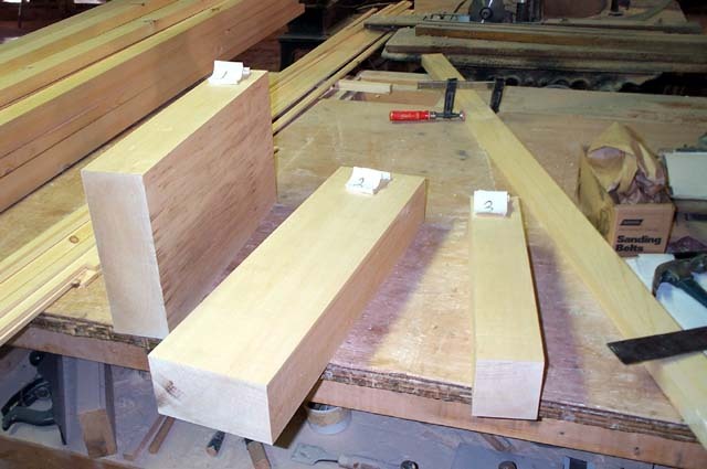 A few large pieces of lumber on a workbench
