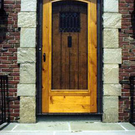 A beautiful arched screen and storm combination door.